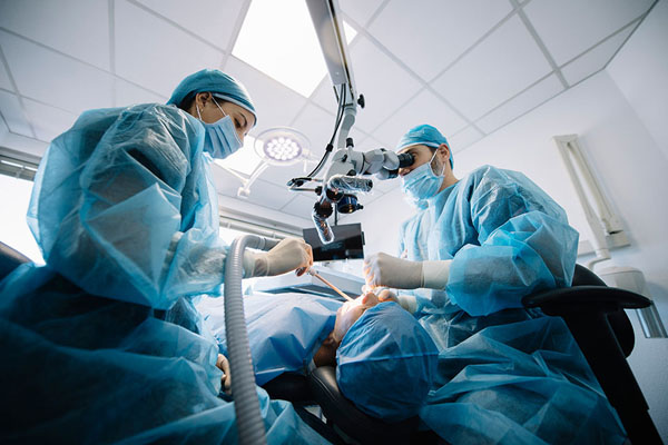 dentists performing a dental procedure on a patient.