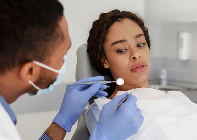 dental patient looking worried at dental tools