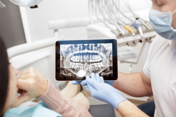 dentist shows patient their digital X-rays