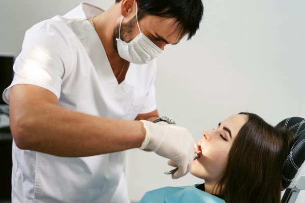 young woman has a tooth extracted
